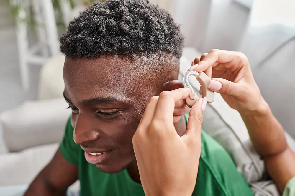 man having hearing aid fitted